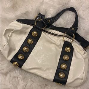 Black and white leather handbag with gold accents